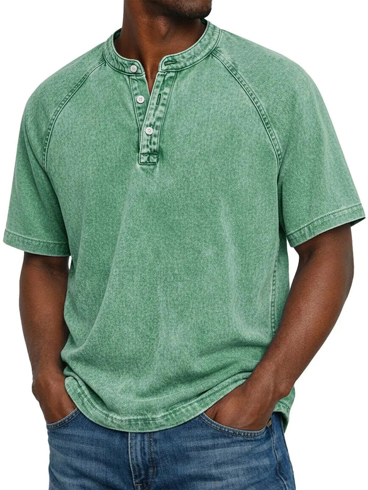 Men's washed raglan-sleeve henley in bright mint green, front view with hands in jeans pockets