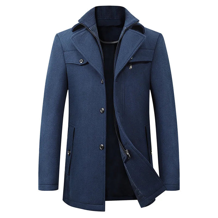 Front view of the blue version of the coat, showing the ribbed inner collar, button placket and zipper inner layer slightly open. 3
