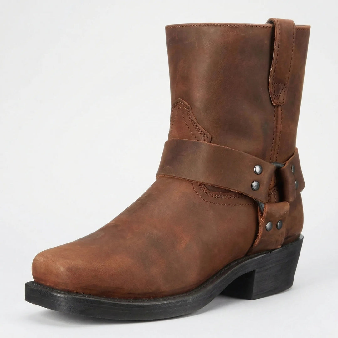 Brown leather mid-calf boot with a studded harness strap and square toe, shown at a three-quarter angle on a light background. 2