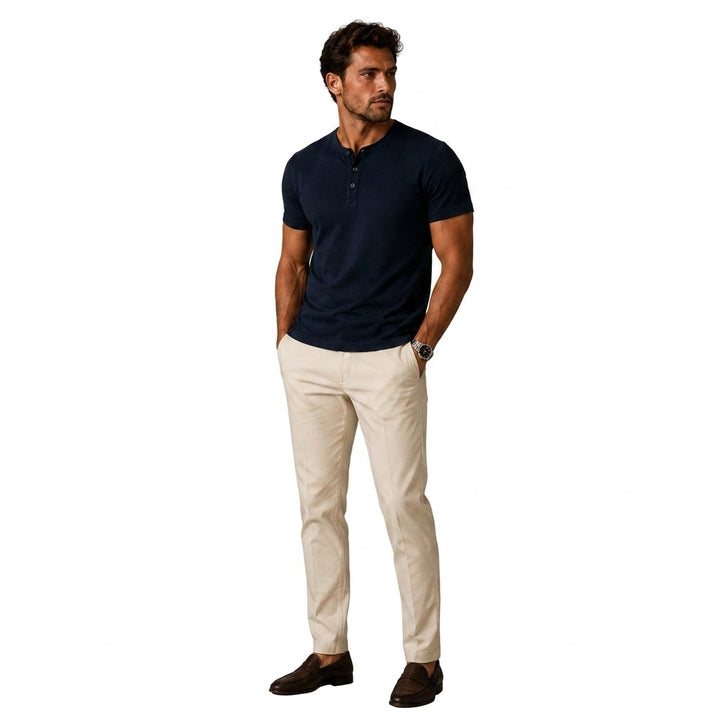 Navy short sleeve top as another view, worn with beige chinos and brown loafers.