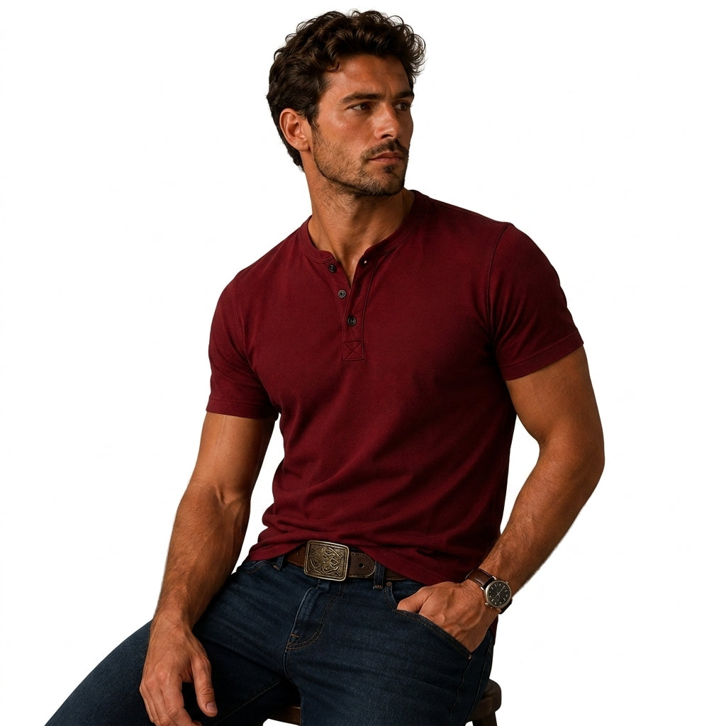 Burgundy short sleeve top as another view, worn seated with dark jeans and a brown belt.