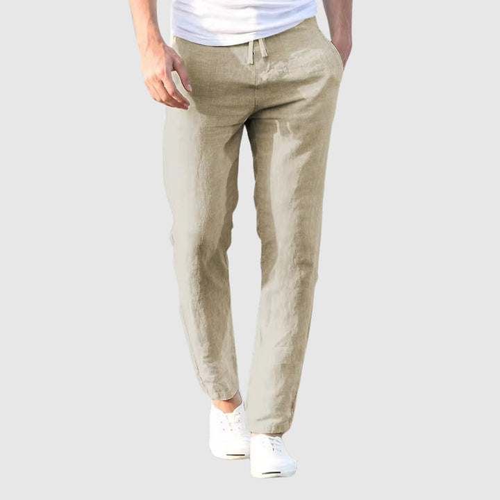 Men's light beige drawstring pants, front view.