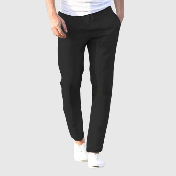 Men's black straight-leg drawstring pants, front view.