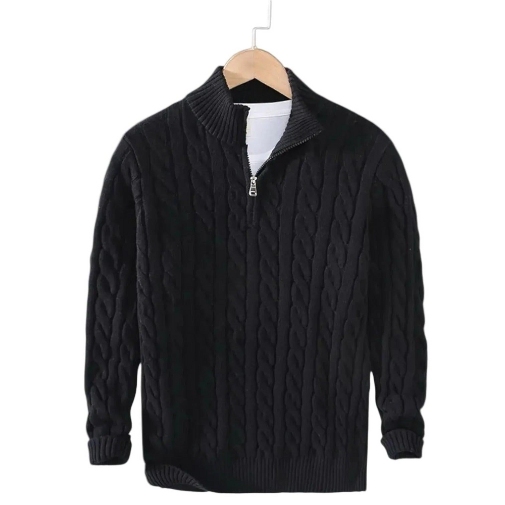 Black cable knit sweater with silver zipper hanging on a wooden hanger over a white tee 2