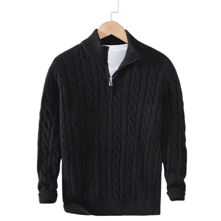 Black cable knit sweater with silver zipper hanging on a wooden hanger over a white tee 2