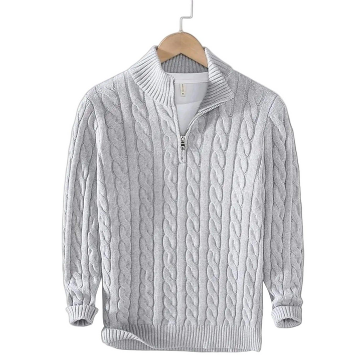 Light gray cable knit sweater with a short zip and ribbed collar on a wooden hanger 4