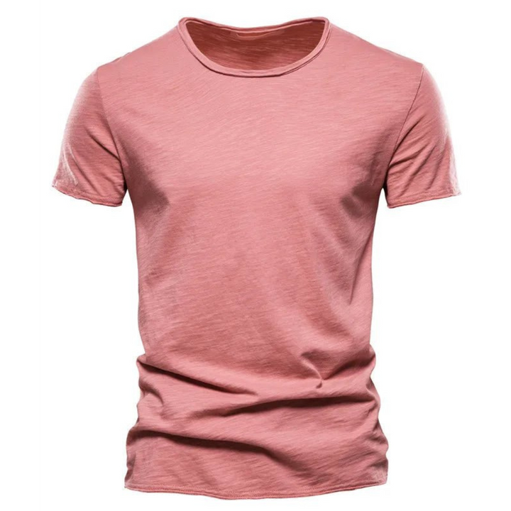 Men's short-sleeve crew neck tee in dusty coral pink with visible slub yarn texture.