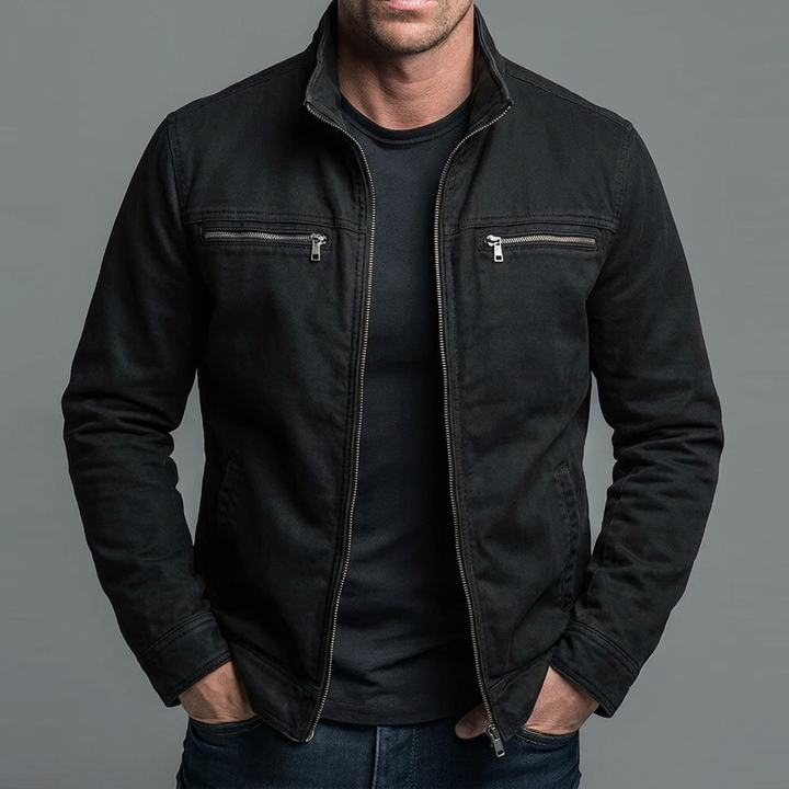 Kylian jacket in black with silver-tone zippers worn open over a black tee.
