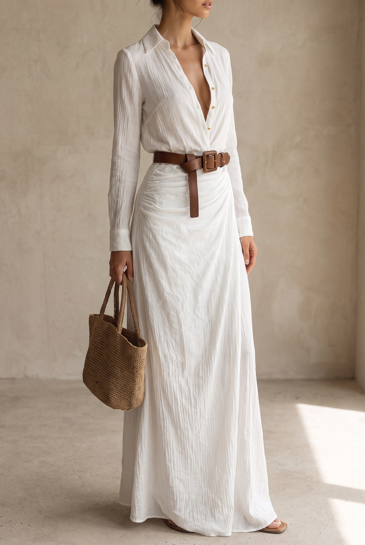 Yellow long-sleeve maxi dress with gold buttons and a knotted brown belt, model holding a woven straw tote.