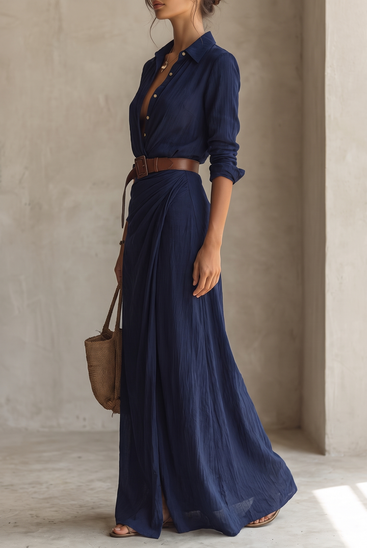 Yellow maxi dress worn with a brown belt, side view of the model carrying a woven straw tote.
