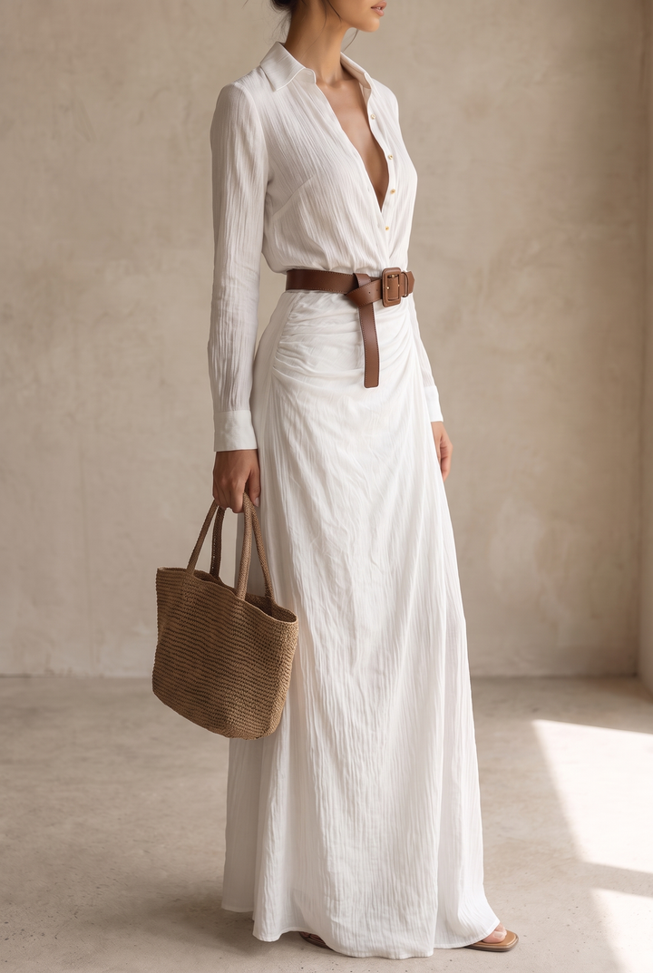 Slightly wider side view of the yellow belted maxi dress with a gathered waist and woven tote in hand.