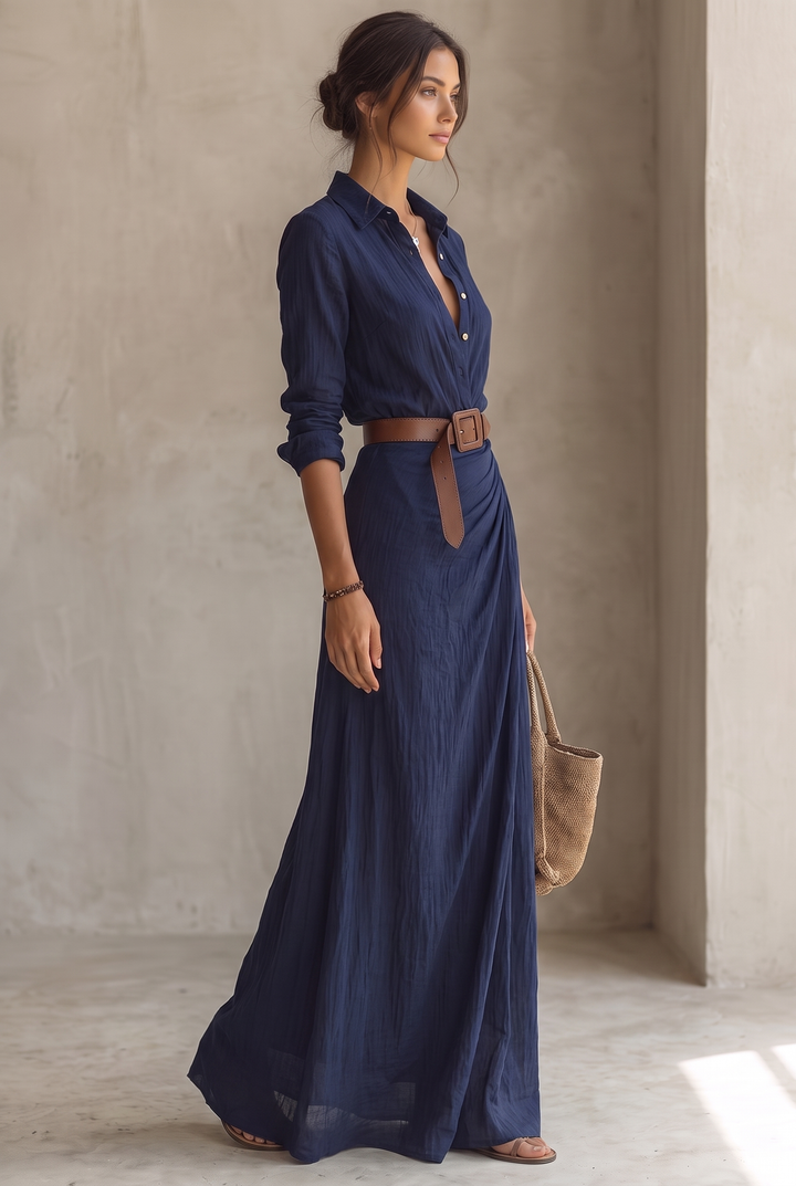 Yellow belted maxi dress in profile, model with a bracelet holding a woven tote beside her.