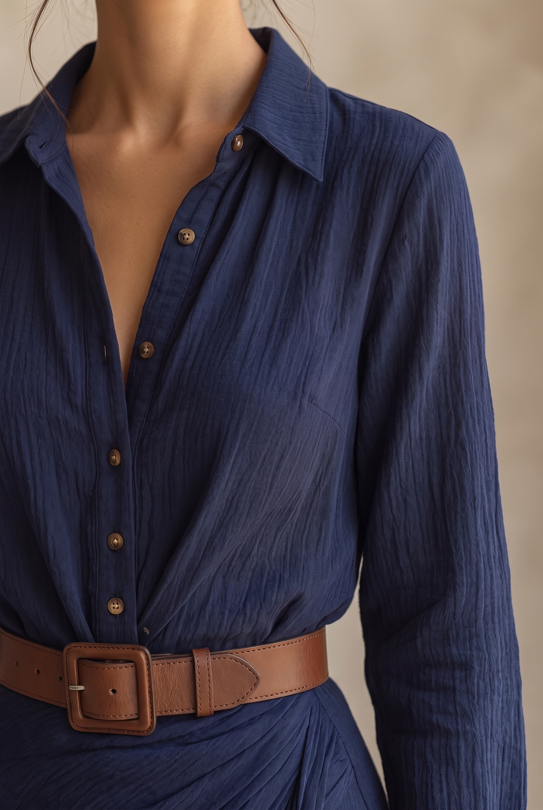 Close-up of the yellow dress showing the collar, brown buttons, textured crinkled fabric and wide leather belt with covered buckle.