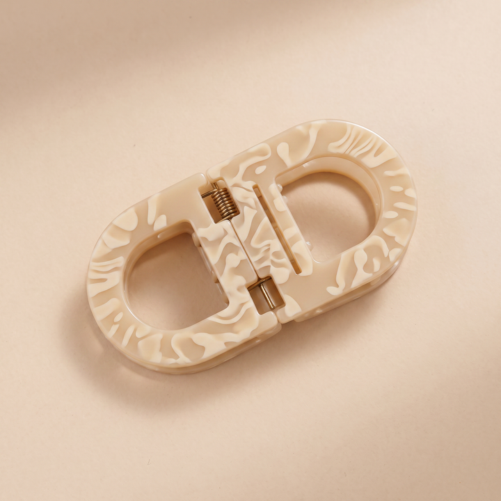 Flat Grip Magnetic Hair Clip in cream-beige acetate, shown from above on a neutral background.
