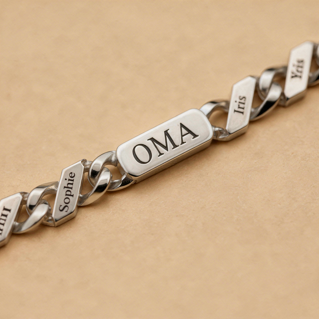 Close-up detail of the silver-tone bracelet's engraved center bar and name links