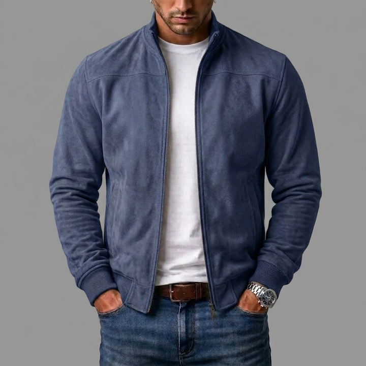 Navy blue suede bomber worn open by a model over a white tee and jeans, hands in pockets. 6
