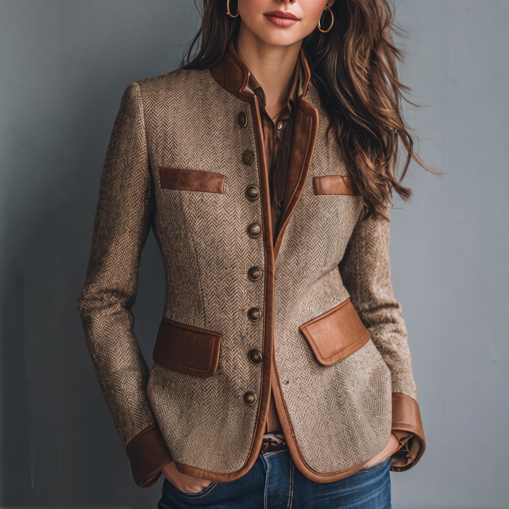 Close three-quarter view of the herringbone jacket worn open over a brown blouse and jeans 1