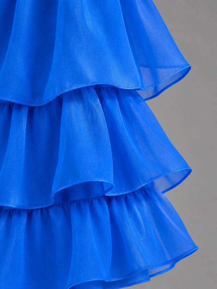 Close-up detail of the royal blue sheer tiered ruffles, showing gathered seams and narrow hems. 26
