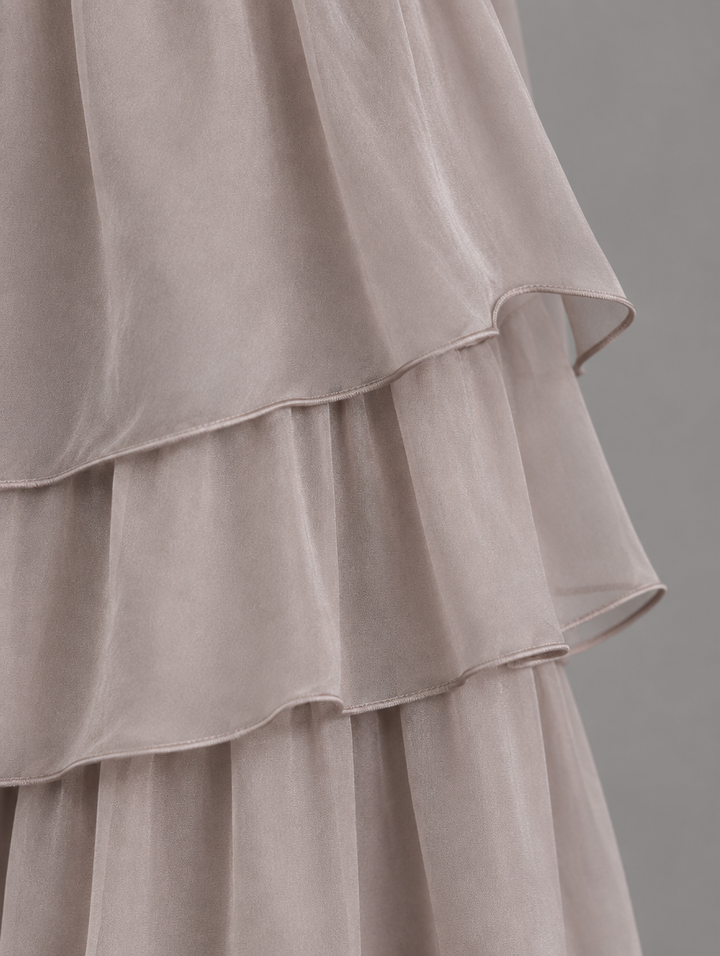 Close-up of the taupe chiffon skirt with layered tiers and neatly finished hem edges