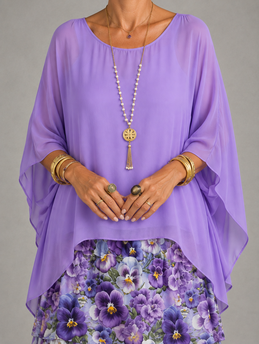 Close-up of the lavender sheer chiffon overlay with wide batwing sleeves, styled with a long pearl necklace and gold bangles over the floral skirt. 42