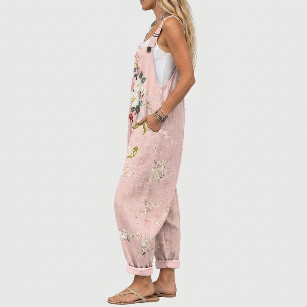 Pink floral overalls, side view showing the relaxed fit and buttoned strap detail.