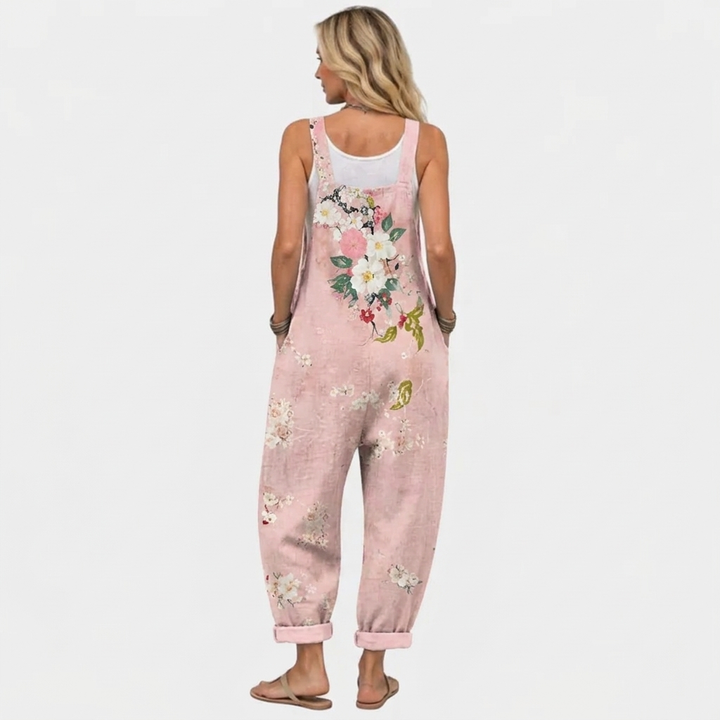 Pink floral overalls, back view with large flower print and rolled hems.