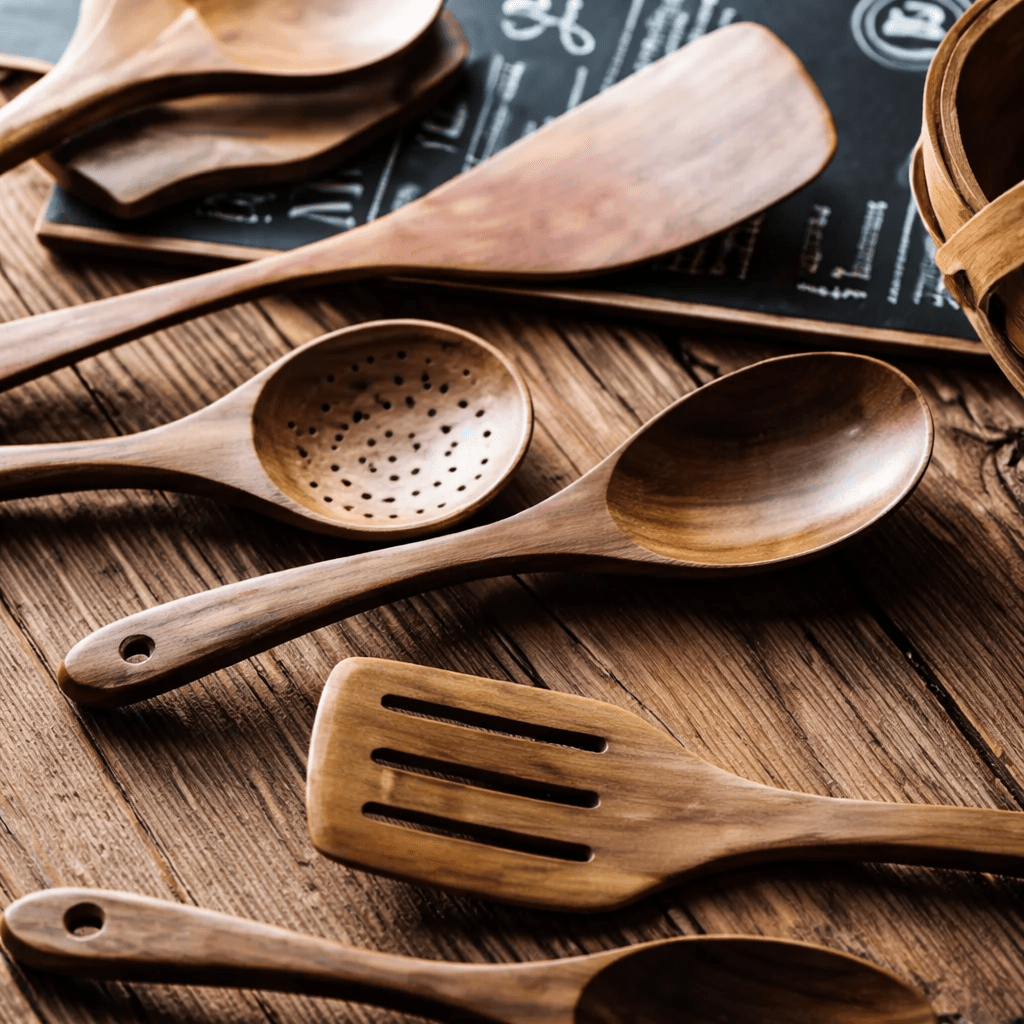 Close-up of wooden utensils on a weathered wooden table.