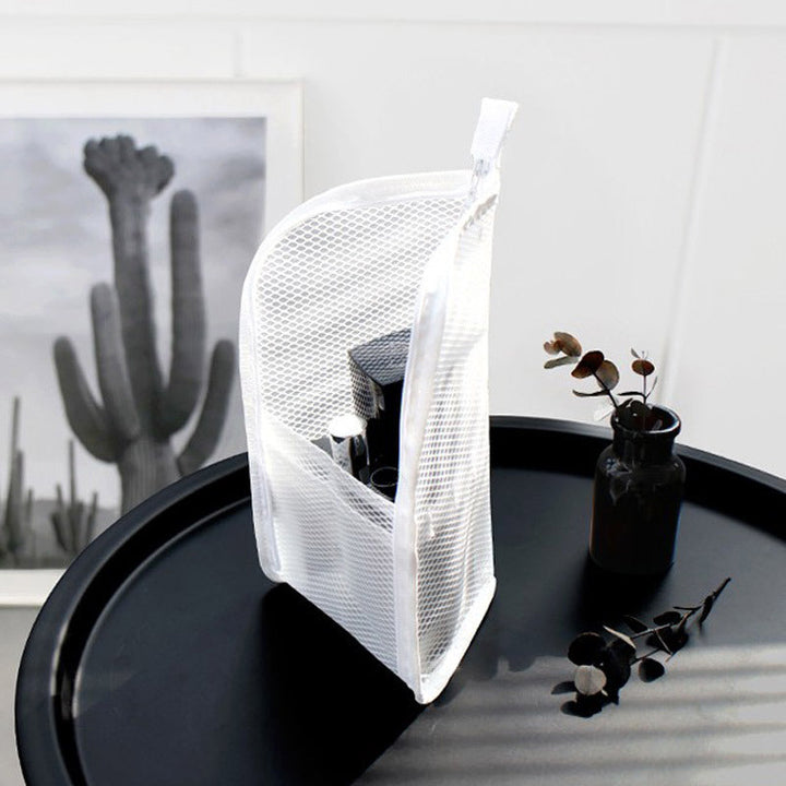 White EVA travel toiletry organizer pouch standing upright with toiletries inside, another view.