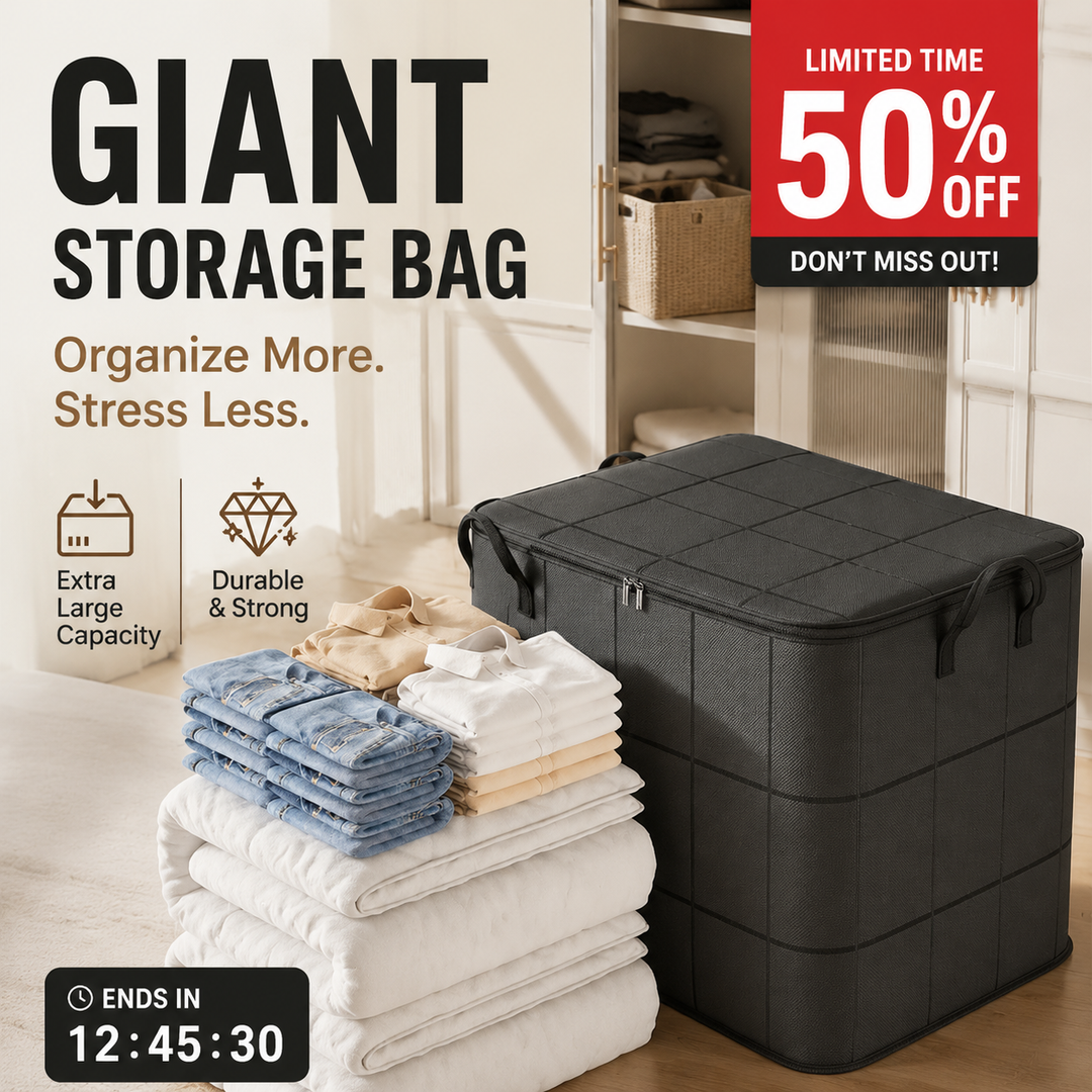 Large dark gray grid-pattern storage bag beside neatly folded jeans, shirts and white comforters on a wood floor 4