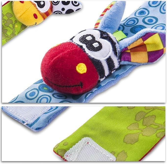 Close-up of a plush zebra wrist rattle with a red nose and blue strap.