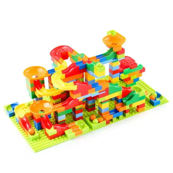 Medium-sized multicolor marble run building set on a lime green baseplate with orange funnels and red slides.