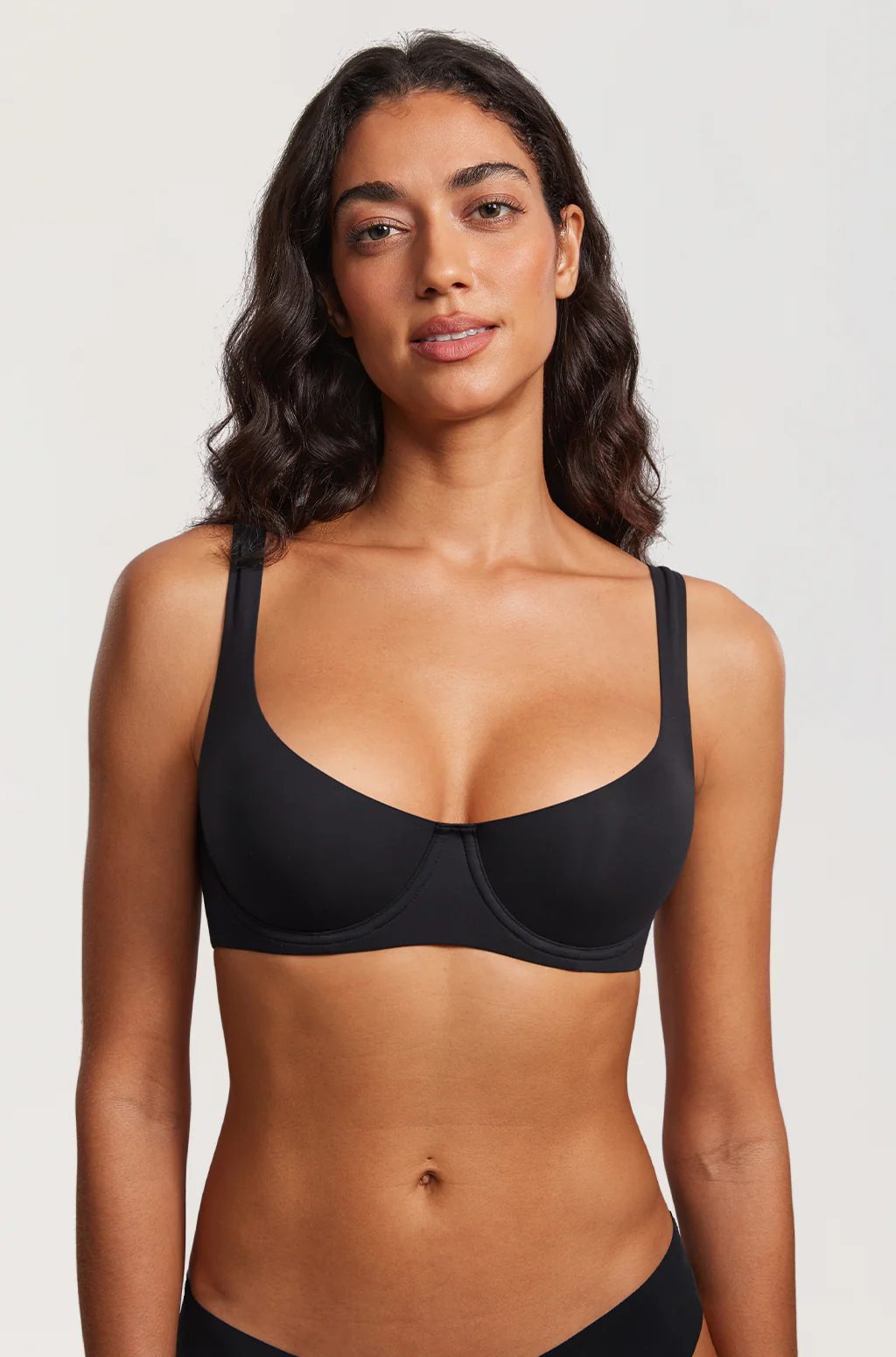 Front view of a black underwire balconette bra and black briefs.