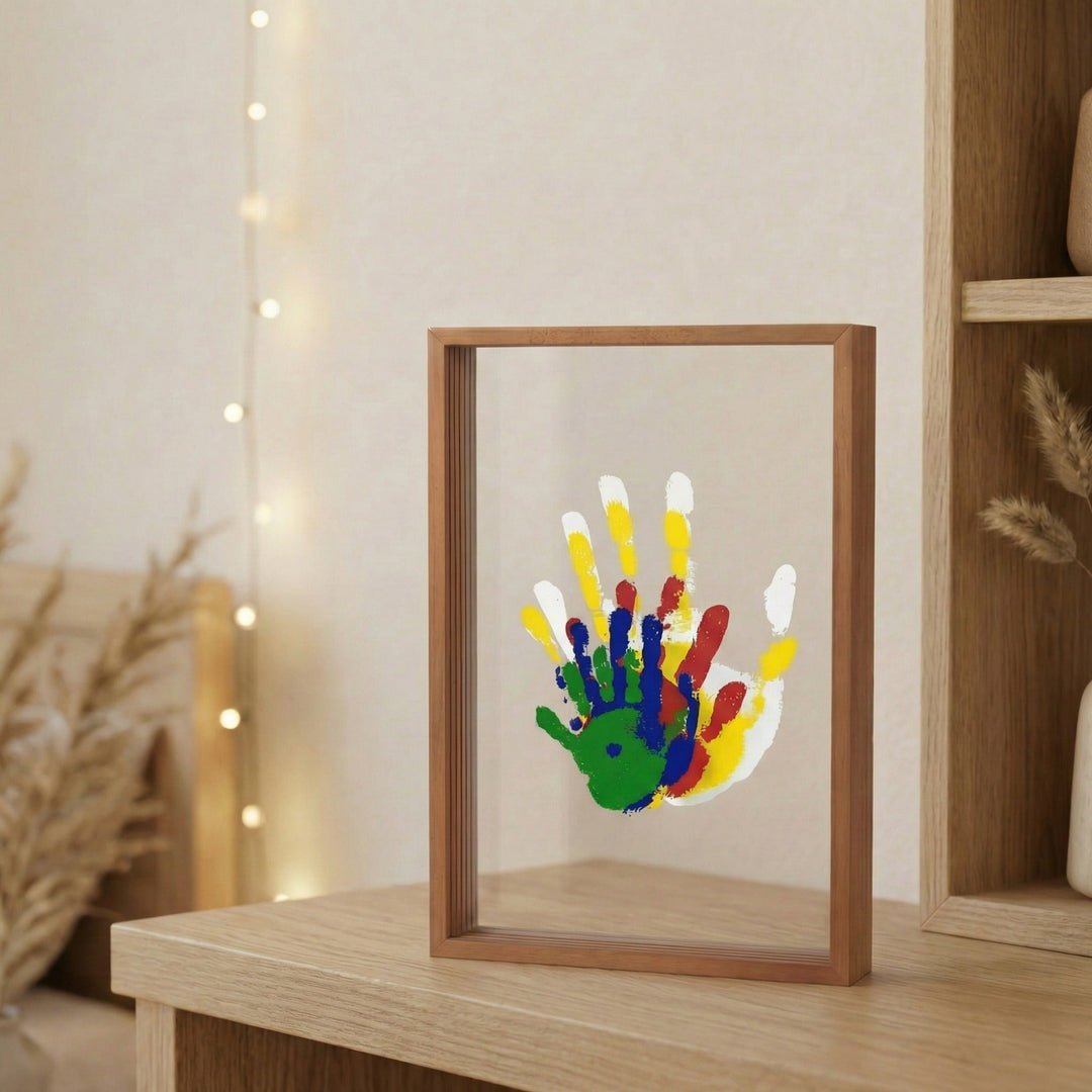 Family Handprint Keepsake Kit with Frame in a brown wooden float frame with clear panels and stacked handprints