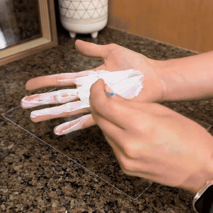 Family Handprint Keepsake Kit with Frame detail showing a hand being coated with white paint