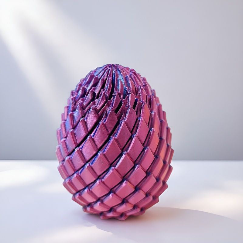 Pink and purple scaled egg on a white surface with soft window light 10
