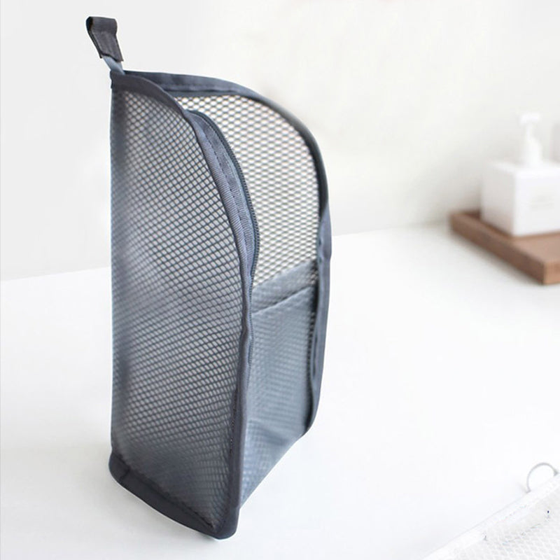Gray EVA travel toiletry organizer pouch standing upright with the front pocket and top hanging loop visible.