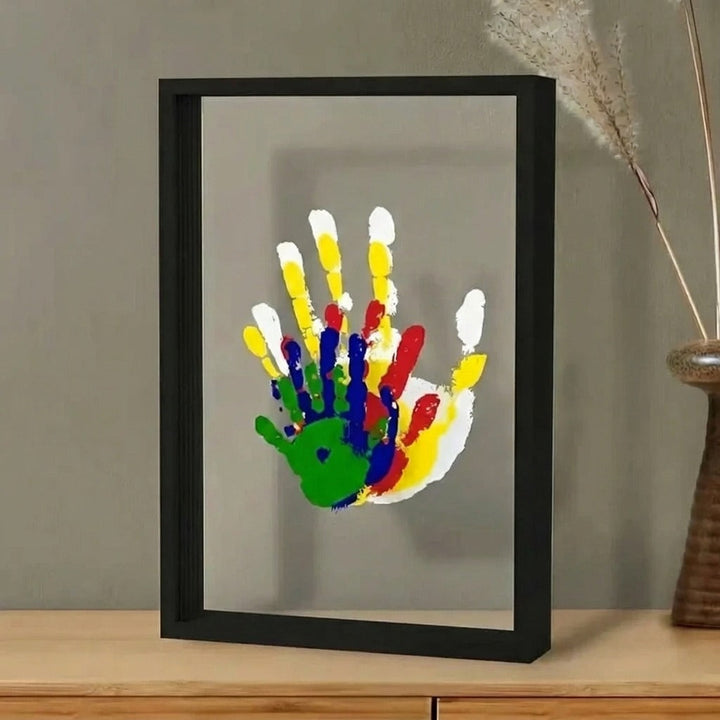 Family Handprint Keepsake Kit with Frame in a black frame with clear panels and a colorful handprint arrangement
