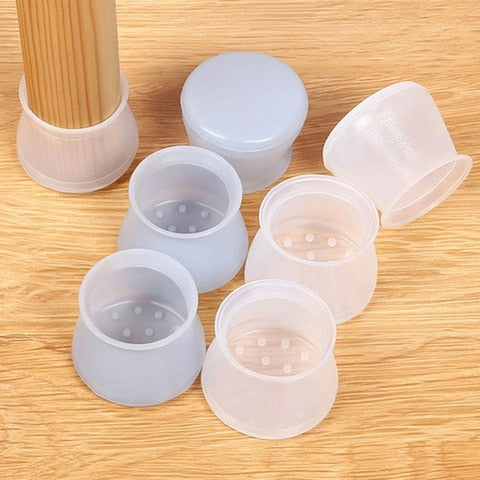 Six loose translucent silicone caps in different tints on a wood surface, one fitted on a leg 3