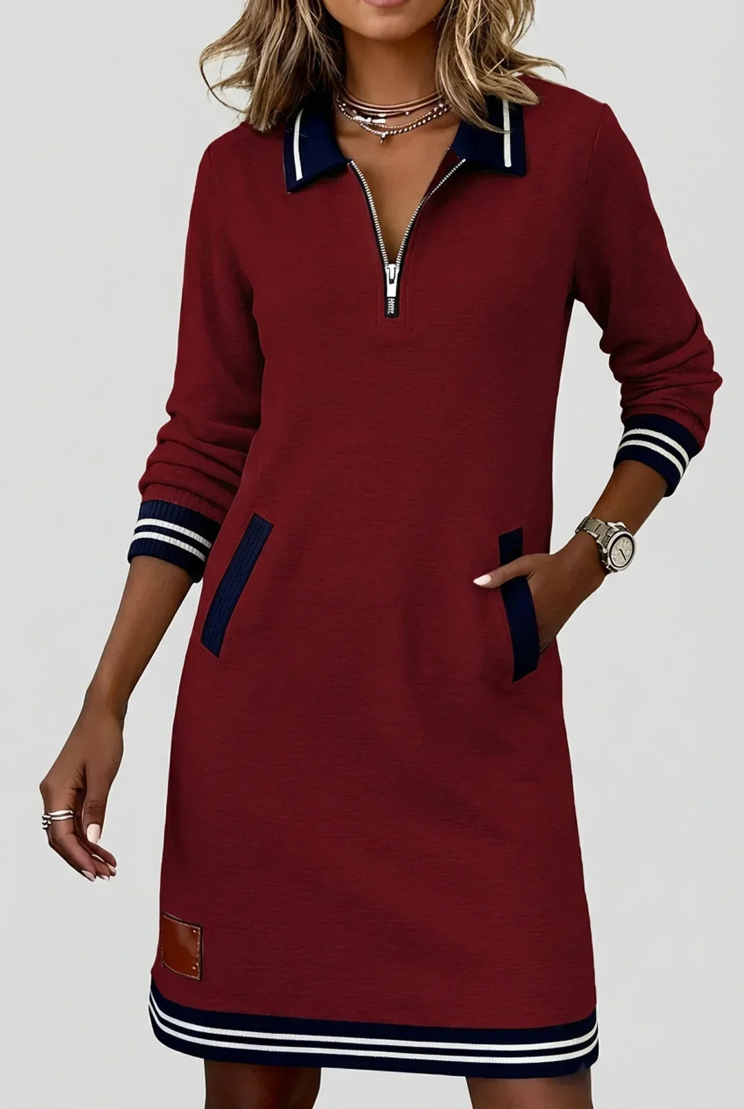 Model wearing the burgundy red version with navy striped collar and cuffs, one hand resting in a side pocket. 5