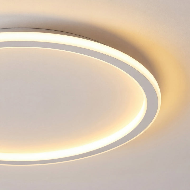 Detail of the white ring fixture's rim with soft diffused glow