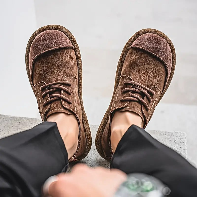 Dark brown leather lace-up shoes another view worn with black trousers, showing the wide toe caps and contrast stitching.