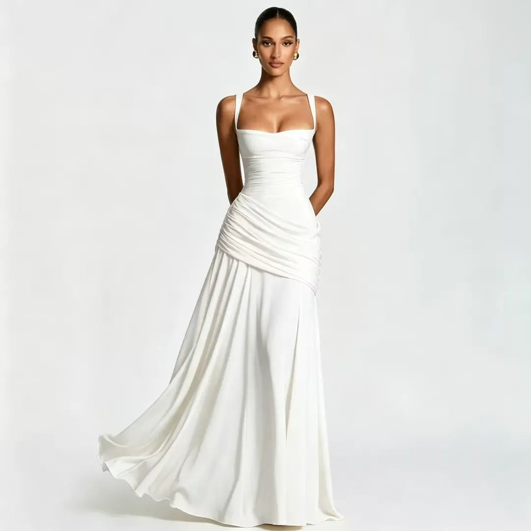 Model in a white maxi dress with square neckline and draped gathered waist, skirt flowing outward