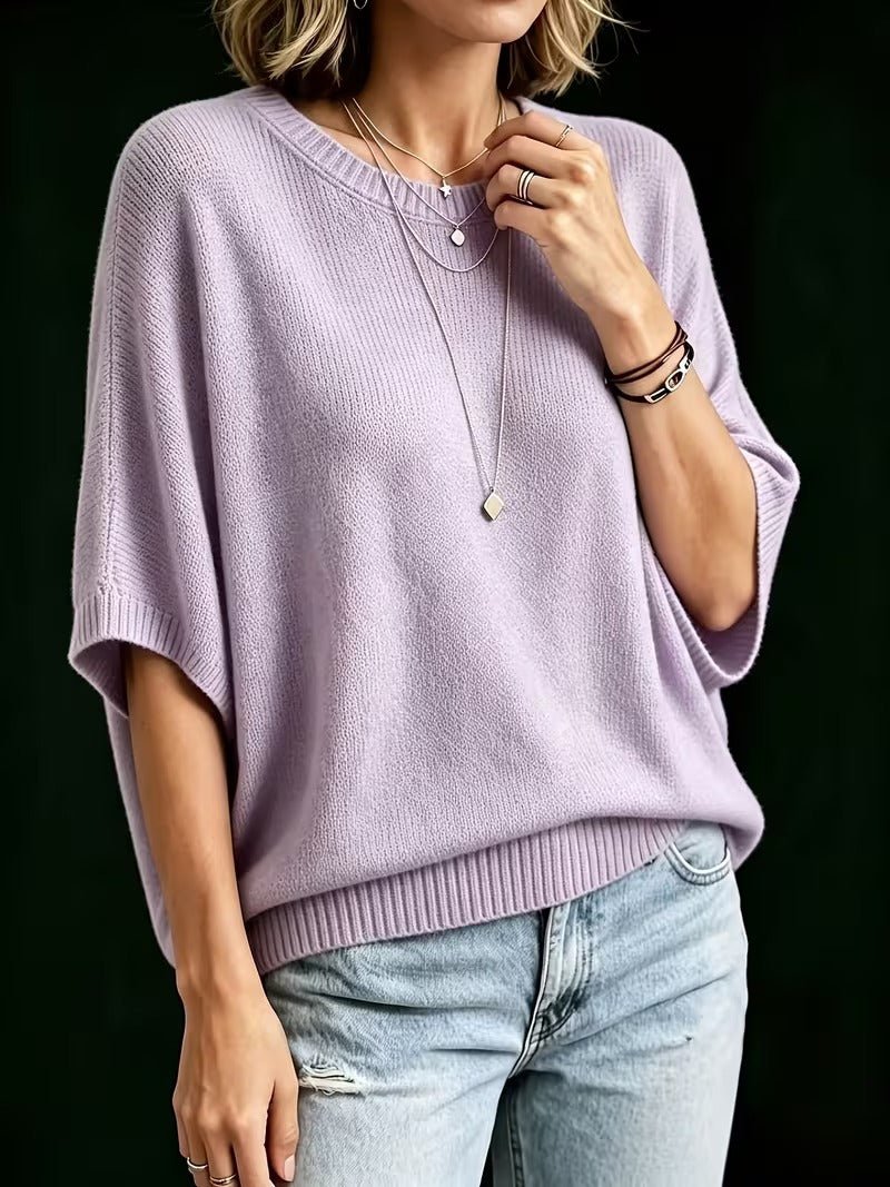 Lavender knit top, front view on a model showing the roomy batwing sleeves and ribbed hem.