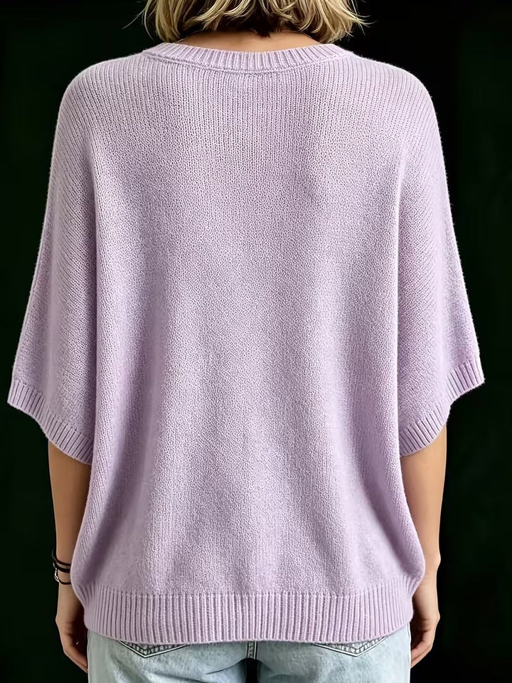 Lavender knit top, back view showing the ribbed round collar, elbow-length batwing sleeves and ribbed bottom edge.