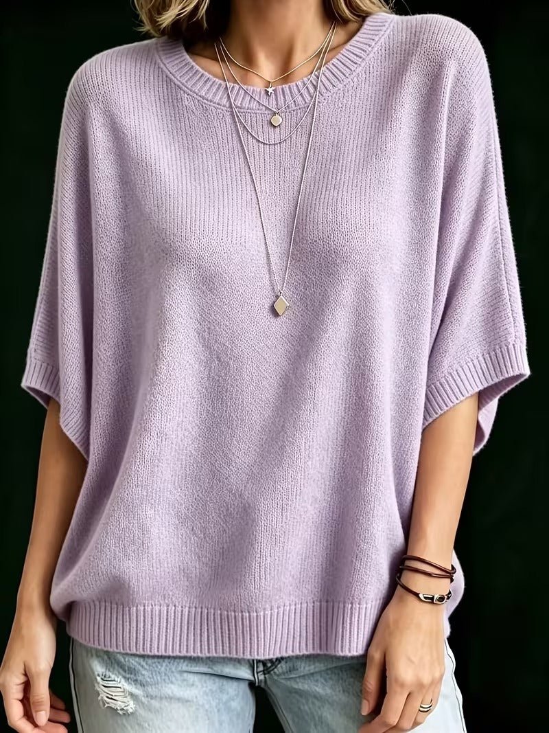 Lavender knit batwing top, straight front view with ribbed cuffs and hem, layered pendant necklaces.