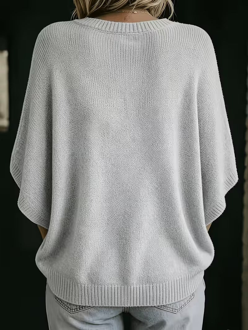 Light gray knit top, back view showing the ribbed round neckline, wide sleeves and ribbed bottom hem.