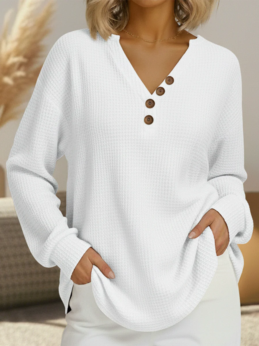 White waffle knit V-neck top with four brown buttons along the placket, worn with white skirt 12
