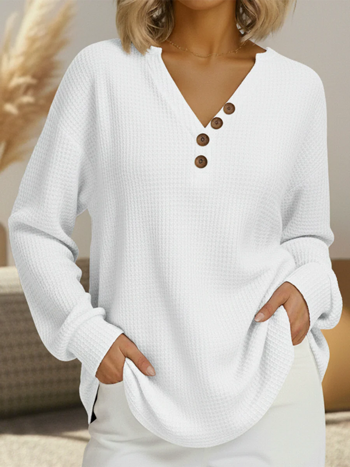 White waffle knit V-neck top with four brown buttons along the placket, worn with white skirt 12