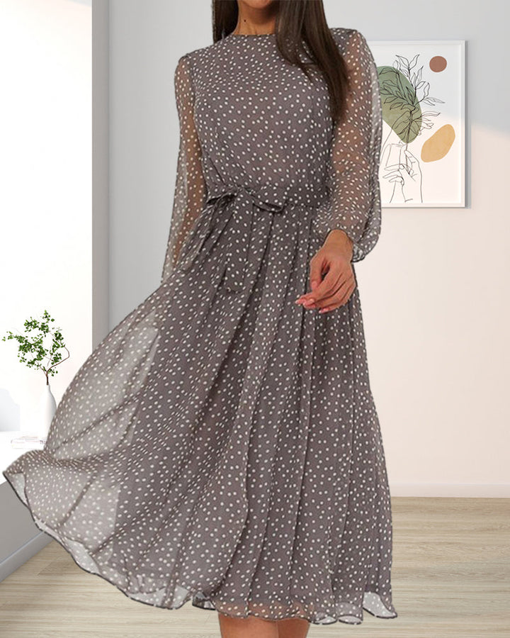 Gray polka dot dress with sheer sleeves and a flared skirt, another view.
