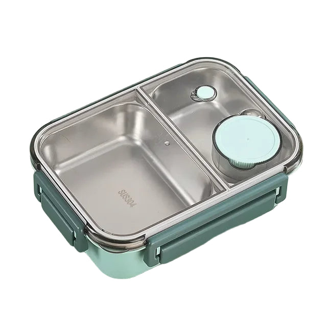 Two-compartment stainless steel lunch box with a clear lid, mint green latches and a small round sauce container, shown in green. 1